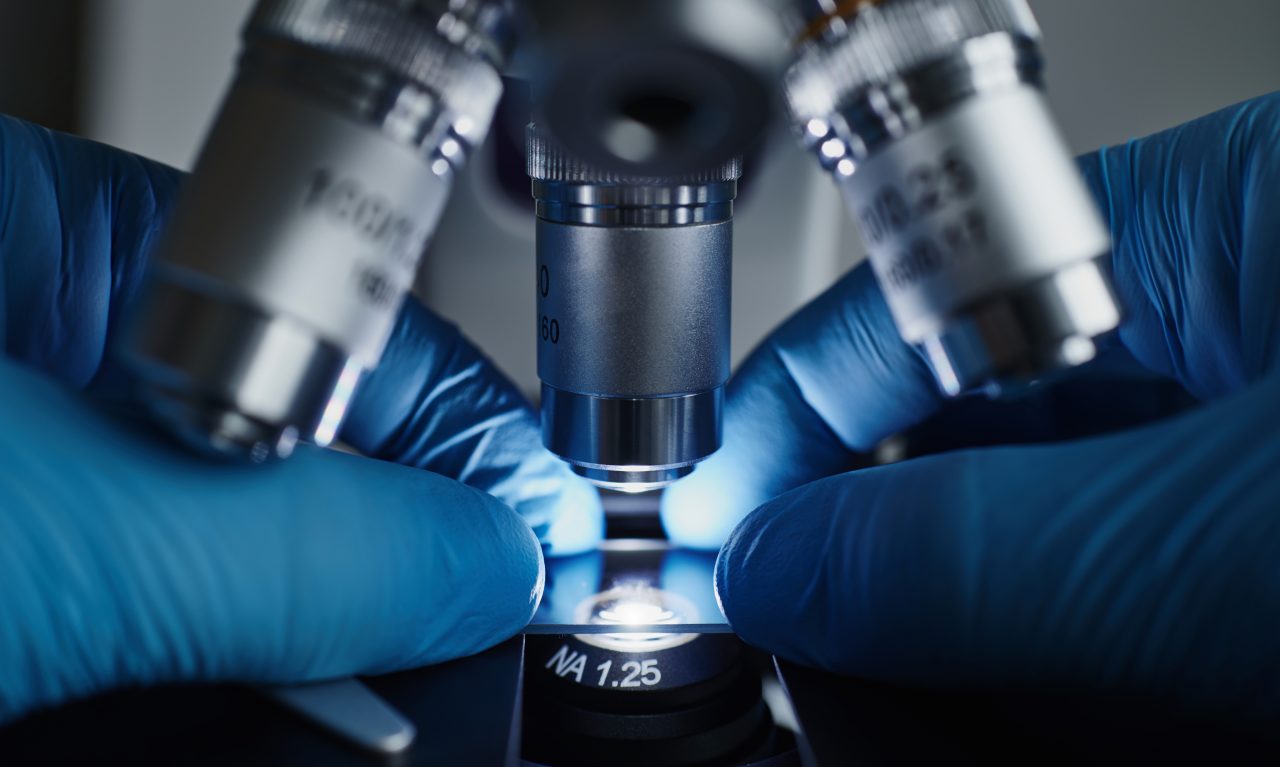 scientist-hands-with-microscope-ZJPLQ6N-1280x767.jpg