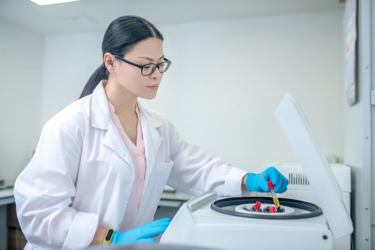 technician-in-blue-gloves-inserting-glass-tubes-to-53K47C7-scaled-1280x854.jpg