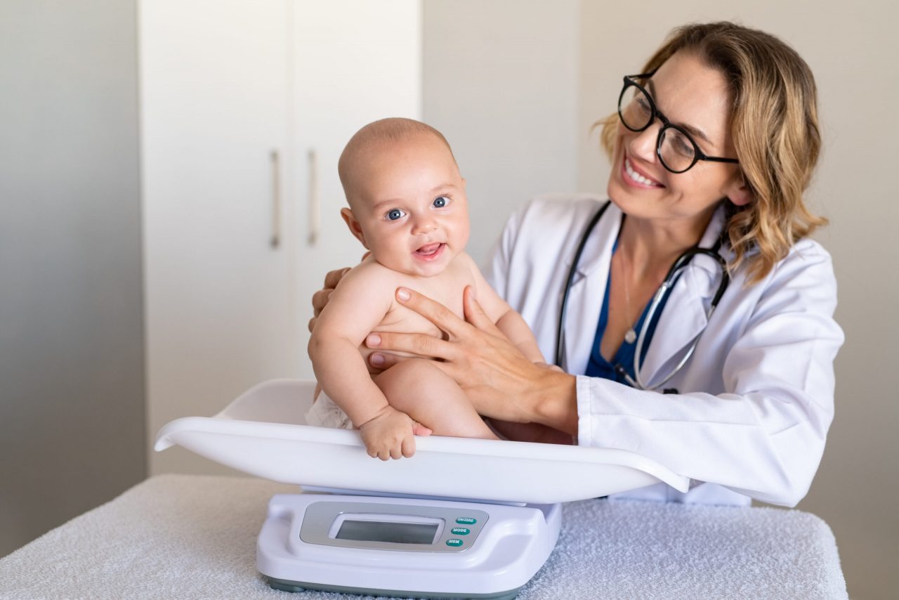 smiling-pediatrician-weighing-cute-baby-2021-08-27-18-49-24-utc-scaled-1280x854.jpg